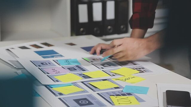 UX graphic designer planning application process development prototype wireframe for web smart phone. Creative digital development agency. in office