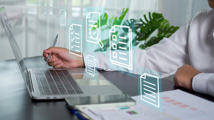 Businesswoman holds pen and checklist for filling out online survey form and has DMS document management system as quality control and validation
