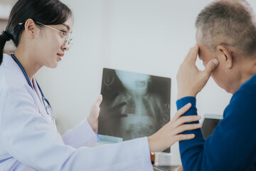 Fototapeta premium Professional female doctor smiles and shows positive test results to elderly male patient at doctor's appointment in modern office of medical institution
