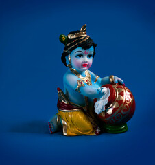 Hindu God Krishna on blue background indian dahi handi festival