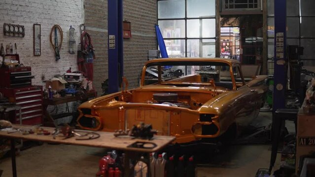 Car Body Shop Interior Shot. Camera Circling An Old Vintage Car With A Fresh Coat Of Paint.