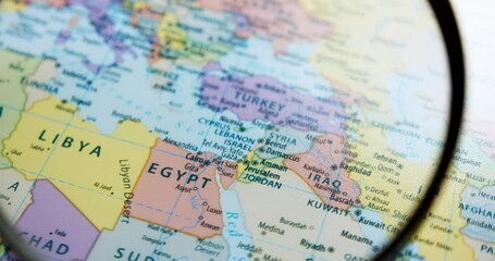 Using a magnifying glass, showing a close-up of the countries in the Middle East such as Israel, Egypt, Iraq, Iran, Lebanon, Jordan, Kuwait, Saudi Arabia, and many  more.