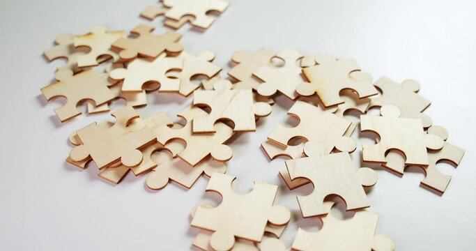 Close-up shot of pieces of a puzzle related to business, marketing, investments, management, networking, and other things pertaining to economics.