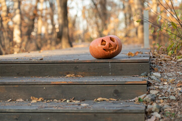 jack o lantern in the garden. Halloween pumpkin head jack lantern on wooden steps
