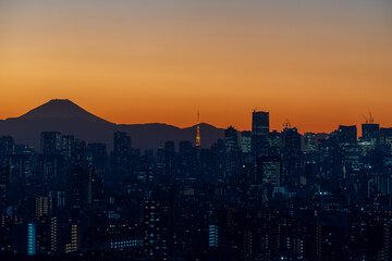 Fototapeta na wymiar Skyline of mount fuji and A part of Japan tokyo tower in downtown tokyo with sunset