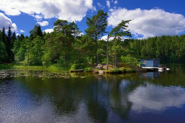 Beach with a red cabin on island on the Dalslands canal