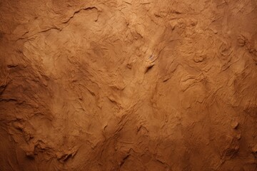 Fototapeta premium A weathered and worn brown wall covered in earthy debris