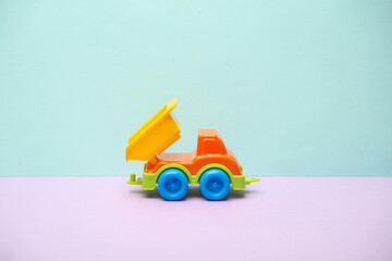 Toy dump truck on a pastel background