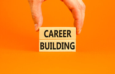 Career building symbol. Concept words Career building on beautiful wooden block. Beautiful orange table orange background. Businessman hand. Business, motivational career building concept. Copy space.