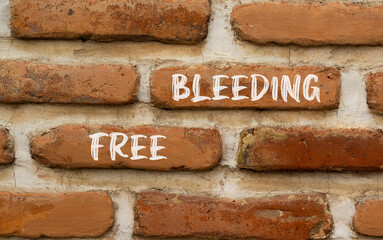 Free bleeding symbol. Concept words Free bleeding on beautiful brown bricks. Beautiful brick wall...