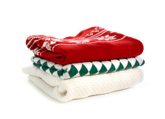 Stack of folded sweaters on white background.Christmas clothes stack.