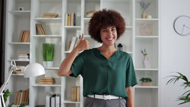 business, startup, people, gesture concept - happy young african woman showing hand sign thumb up dancing