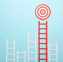 Paper red and white stairs and target on blue background. Business concept