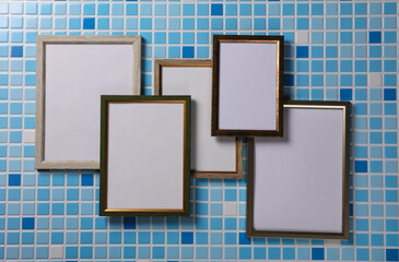 Group of blank frames on a tiled wall