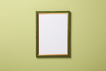 Blank wall frame on green background