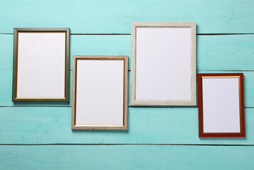 Blank wall frames on blue wooden background