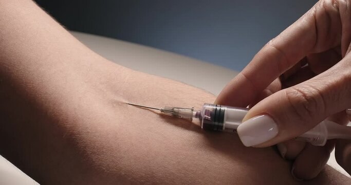 The nurse takes blood sample from vein. Blood analysis, laboratory examination of a sample of blood. Clinical research
