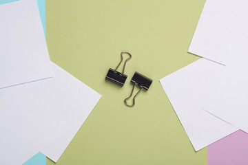 Paper binders on green background