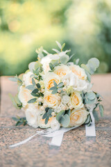 wedding bouquet of various flowers. the buds are pink, purple, green, cotton. bokeh