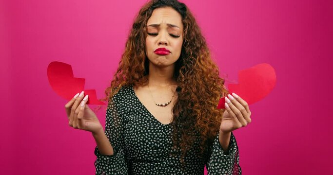 Brokenhearted young woman holds the pieces after break up, divorce