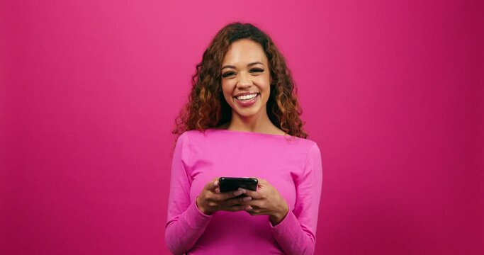 Cute young woman dressed for Valentines Day on dating app cellphone, studio