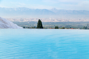 blue water pools in Pamukkale and the city in the background
Turkey