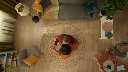 Top view capturing a young happy couple spending time together at home. They are having fun, slow...