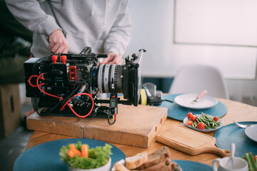 Professional cinema and video camera on the set. Shooting shift, lighting fixtures, shooting equipment and the team.