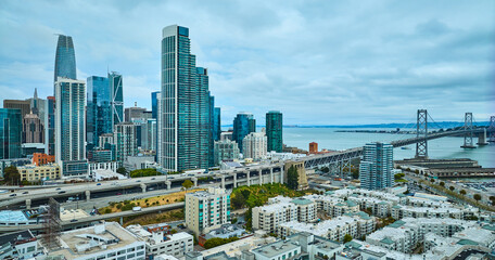 Aerial over Bayside Village with San Francisco skyscrapers and Oakland Bay Bridge