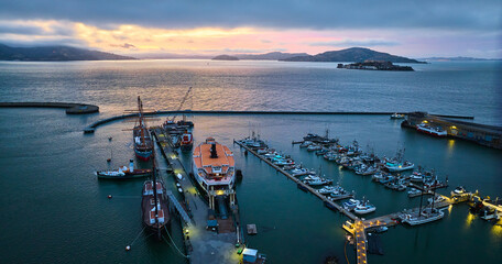 Beautiful sunset lighting over San Francisco Bay with Alcatraz and Hyde St Pier aerial