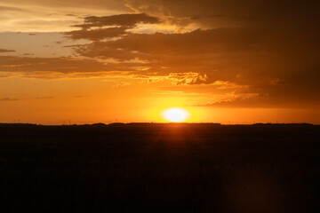 Fototapeta na wymiar Sunsetting over rural Manitoba field