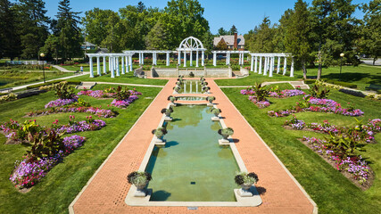 Low aerial pools of water with flowers and white pergola and trellises at Lakeside Park