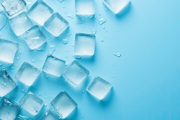 Cubes of ice and drops are isolated on the blue background with empty space.