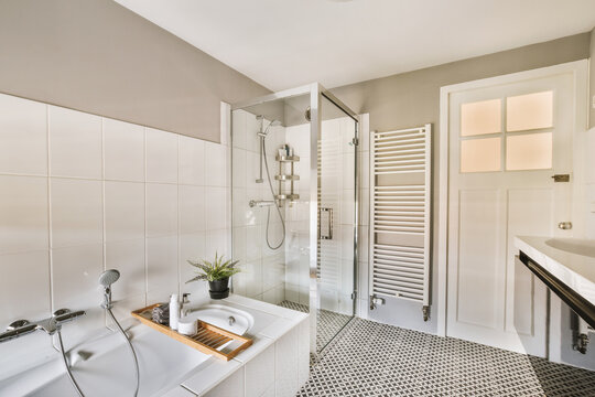 Stylish bathroom with shower cabin and bathtub