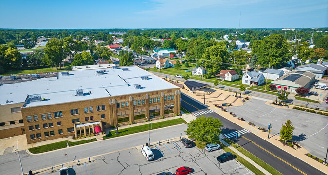 Side entrance aerial view of ACD Automobile Museum with parking lots on bright sunny day
