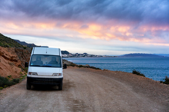 Van by the sea on a dirt road