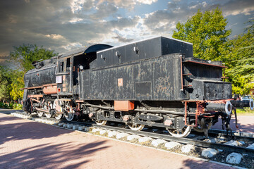 Nostalgic coal-fired steam locomotive exhibited in the garden. Ali Çetinkaya train station,...