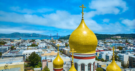 Aerial roof of Russian orthodox Holy Virgin Cathedral with Golden Gate Bridge in distance