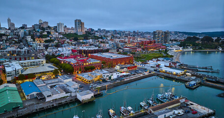 Fototapeta premium Aerial city lights in San Francisco at dusk near Hyde St Pier and Fishermans Wharf on coast