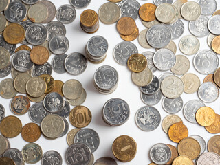 Close-up of a lot of Russian ruble coins on a white background. Some of them are arranged in columns. The concept of wealth, economy, growth, business. Money, coins. Top view