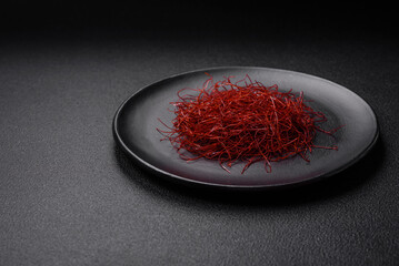 Red thin hot chili threads on a dark background