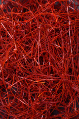Fototapeta premium Red thin hot chili threads on a dark background