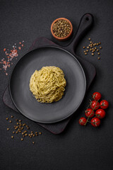 Capellini pasta or noodles with pesto sauce, salt and spices