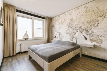 Bedroom with bed and map wallpaper by bright window