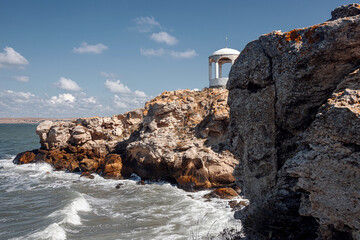 Rocky coastline. The waves break on the rocks. Beautiful landscape. The sky is the sea and the...