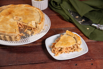 slice of chicken pie on rustic wooden background