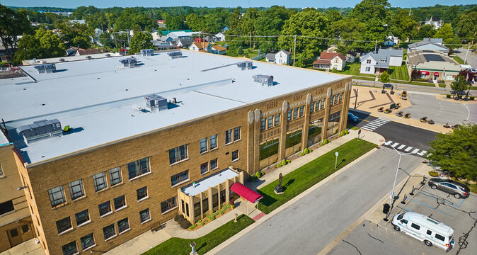 Side entrance of ACD Automobile Museum with parking lot on bright sunny day aerial