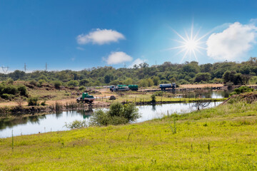 africa shortage of clean water, trucks loading water from a dam