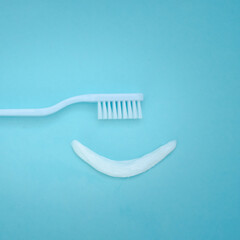 Smiley face created from paste with white Toothbrush. Care for oral and dental care concept....