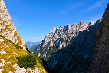 Vrata valley and mountain peak lit by sunlight rising above in Gorenjska, Slovenia